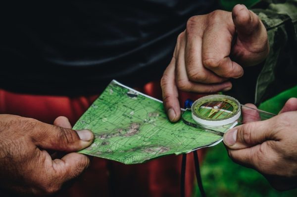 Hands holding map and compass